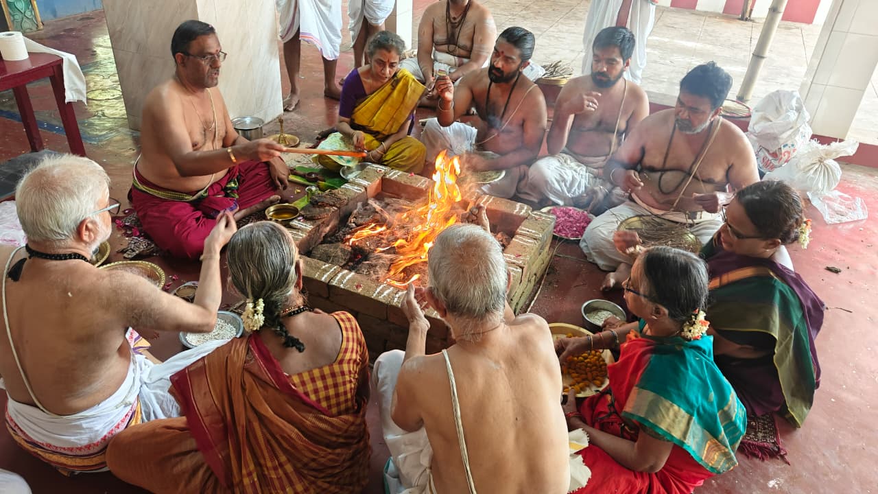 A group gathered around a sacred fire with offerings